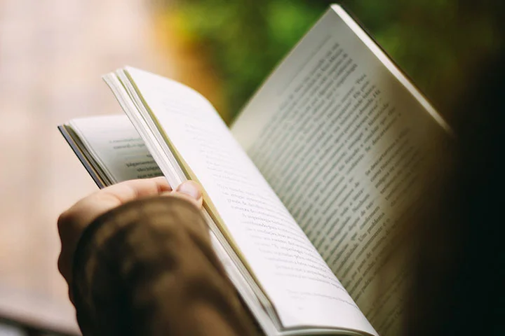 Researcher reviewing an academic book during publication preparation